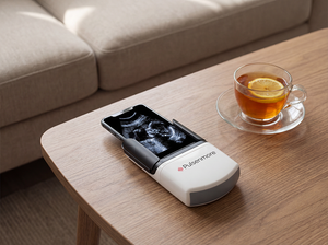 Pulsanmore device on a wooden table with a cup of tea and lemon.