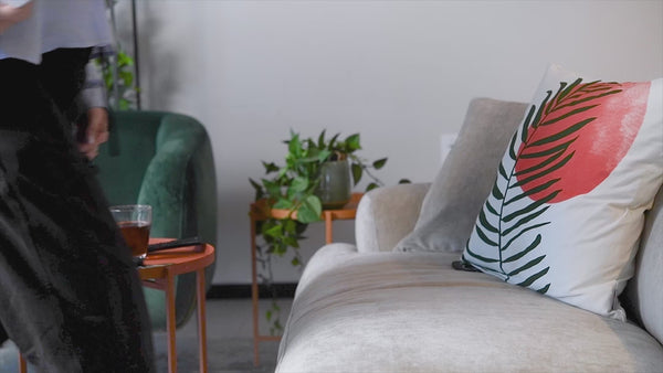 A one-minute video showing a woman sitting down on a couch, picking up her mobile phone and opening the Pulsenmore app. She then takes the Pulsenmore home ultrasound device out of its packaging and connects her phone to the device. Next, she unbuttons the lower part of her light blue shirt and applies gel to her pregnant belly. She taps the app and begins scanning her belly, while the screen displays the fetus in real time as she gently glides the device over her  abdomen. After completing she disconnects