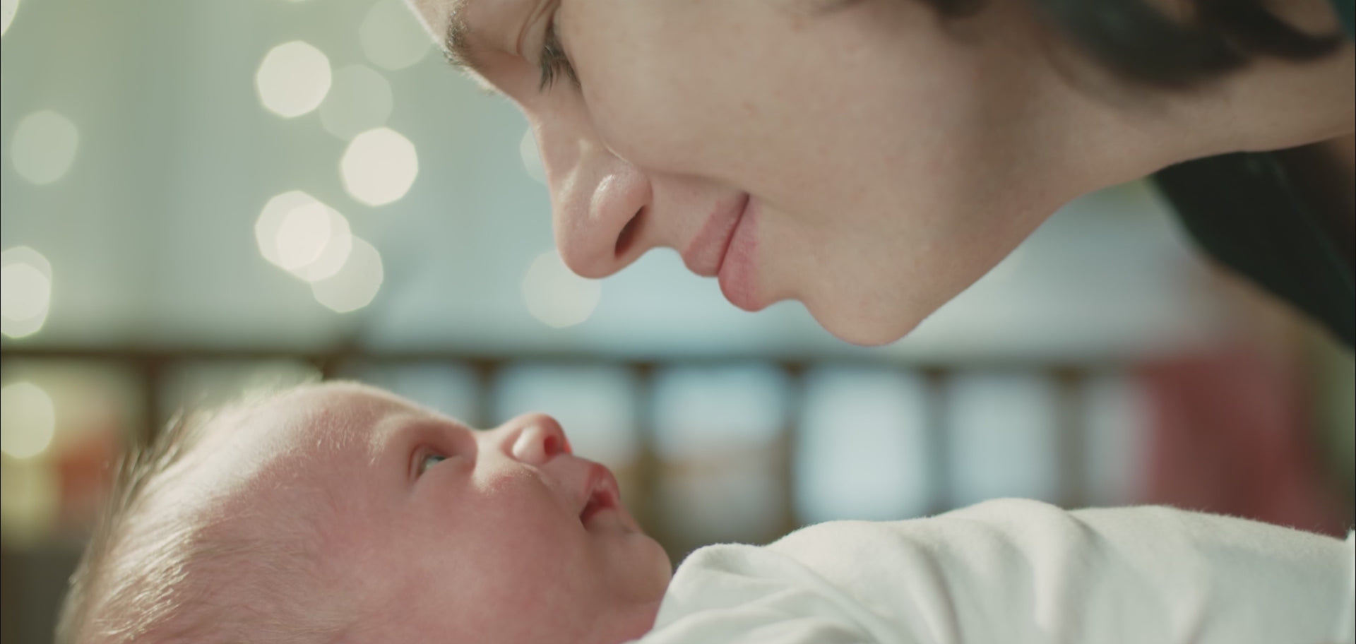 A video showing women with their babies, mothers hugging their children, a woman looking at a baby outfit, ultrasound scans, pregnant women touching their bellies, a woman performing a scan, a clinician viewing and interpreting the scan on a screen, a doctor speaking with a patient, and a patient speaking with a doctor via a computer screen.
